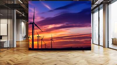 Wind turbines farm agaist the colorful sky at sunset. Renewable and Alternative energy. Wall mural