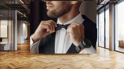 The stylish bridegroom dresses, prepares for the wedding ceremony. The groom's morning. Businessman wears a jacket, male hands closeup, groom getting ready in the morning before wedding ceremony Wall mural