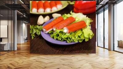 Crab sticks, parsley and lettuce on a plate on the table. Wall mural