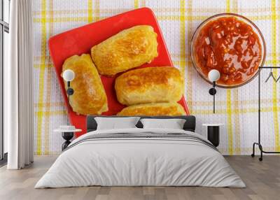 Pastries and sauce on a plate on a napkin. Wall mural