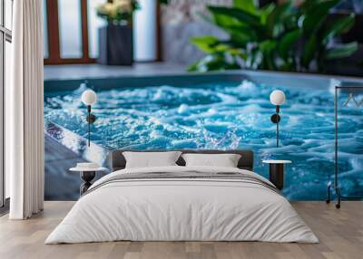 Tranquil blue jacuzzi with bubbling water in a serene spa setting Wall mural