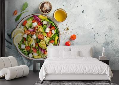 Delicious and healthy green salad of different leaves and vegetables with seeds and olive oil. Wall mural