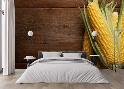 Fresh corn on cobs on rustic wooden table, closeup. Top view with copy space Wall mural