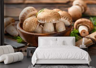 Fresh whole brown mushrooms in wooden bowl with knife on rustic table, autumn harvest of edible fungi Wall mural