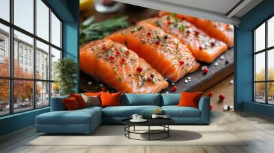 Salmon. Fresh raw salmon fish fillet with cooking ingredients, herbs and lemon on black background, top view Wall mural