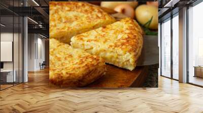 Spanish omelette with potatoes and onion, typical Spanish cuisine. Tortilla espanola. Rustic dark background. Top view Wall mural