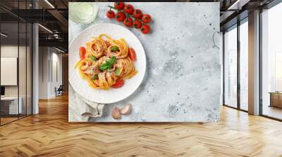 Tasty appetizing classic italian tagliatelle pasta with tomato sauce, cheese parmesan and basil on plate on light table. View from above, horizontal. Top view with copy space Wall mural