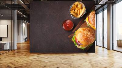 tasty grilled home made burger with beef, tomato, cheese, cucumber and lettuce on a dark stone backg Wall mural