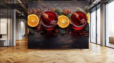 Two glasses of cherry mulled wine, gluhwein or glogg with cherry juice, orange, cinnamon, star anise and cloves. Winter time. Holiday concept, yellow lights of the New Year's eve garland on background Wall mural