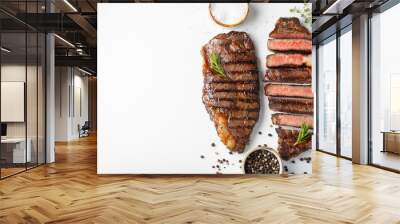 Two grilled marbled beef steaks striploin with spices isolated on white background, top view with copy space Wall mural