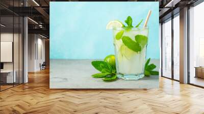 Two homemade lemonade or mojito cocktail with lime, mint and ice cubes in a glass on a light stone table. Fresh summer drink. With copy space. Wall mural