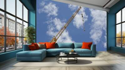 Crane boom on blue sky background. Crane lifting mechanism. Wall mural