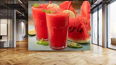 Watermelon slushie with lime, summer refreshing drink in tall glasses on a blue rusty background Wall mural