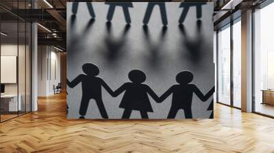 Paper people holding hands on gray surface. Community, brotherhood concept. Society and support. Wall mural