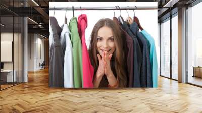 Young woman near rack with hangers Wall mural