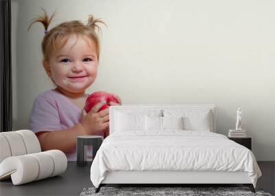 Portrait of a baby with a red apple Wall mural