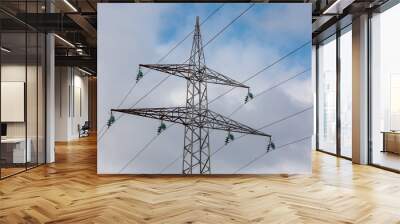 High-voltage electric pole against a cloudy sky Wall mural