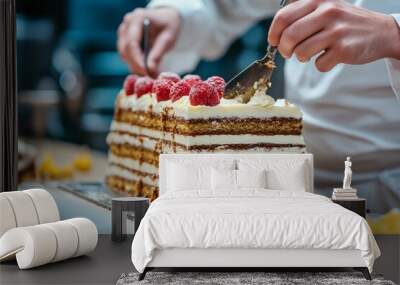 Chef decorating layered raspberry cream cake in professional kitchen setting Wall mural