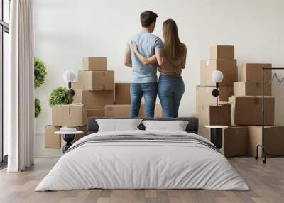 Couple embracing while moving into new home surrounded by boxes Wall mural