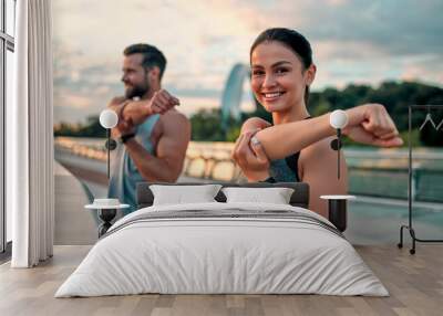 Couple doing sport on the street Wall mural