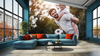 Dad with son playing football Wall mural