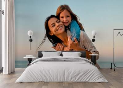 Mother with daughter on the beach Wall mural