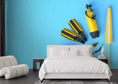 Colorful scuba stuff and beach accessories like umbrellaand sunscreen on blue Wall mural