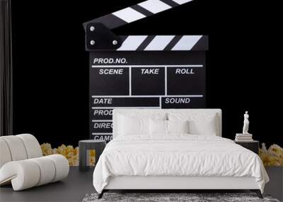 Flying popcorn and film clapper board isolated on black background Wall mural