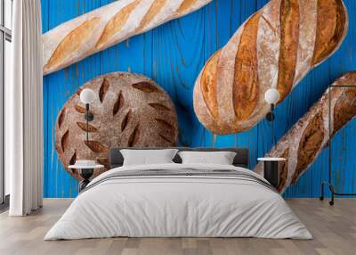 Top view photo of fresh baked bread on painted blue wooden table Wall mural