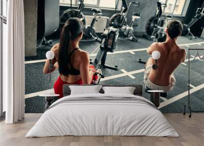 Sporty couple in gym Wall mural