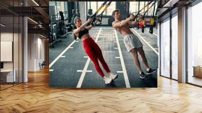 Sporty couple in gym Wall mural