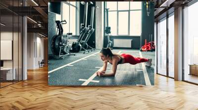 Sporty woman in gym Wall mural