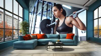 Sporty woman in gym Wall mural