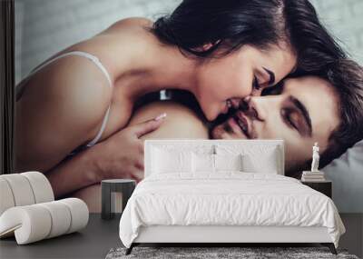 Young love couple in bed Wall mural