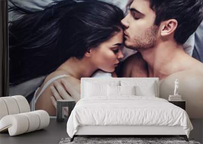 Young love couple in bed Wall mural