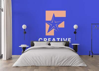 Orange negative space star on letter F logo ini blue background Wall mural