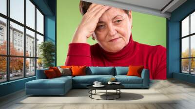 Mature woman suffering from headache Wall mural