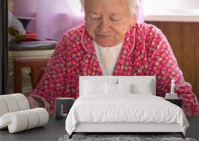 Senior woman eating soup Wall mural