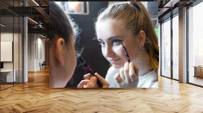 Teenage girl applying make up Wall mural