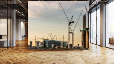 Cranes constructing buildings in London at dawn Wall mural