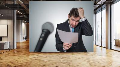 Nervous man is afraid of public speech and sweating. Microphone Wall mural