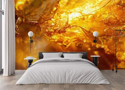 A close-up of a smooth amber gemstone with intricate natural patterns and warm, golden hues. Wall mural