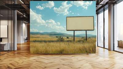 An empty billboard frame against a rural landscape, ready for new advertising content, with fields and distant mountains in the background. Wall mural