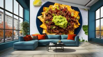 Corn chips nachos with fried minced meat and guacamole isolated on white background Wall mural