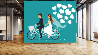 Just married couple bride and groom riding tandem bicycle Wall mural