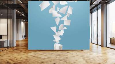 Flying paper and stack of papers on blue background. Wall mural