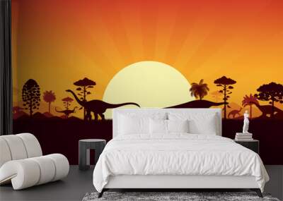 Dinosaurs silhouettes on sunset prehistoric landscape with palm trees, hills and plants. Vector serene background with dino species shadows roaming peacefully in front of large sun in orange dusk sky Wall mural