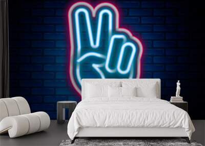 Glowing neon line Hand showing two finger icon isolated on brick wall background. Hand gesture V sign for victory or peace. Colorful outline concept. Vector Wall mural