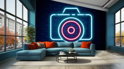 Glowing neon line Photo camera icon isolated on brick wall background. Foto camera icon. Colorful outline concept. Vector Wall mural