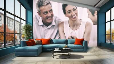 Business people talking together on sofa Wall mural